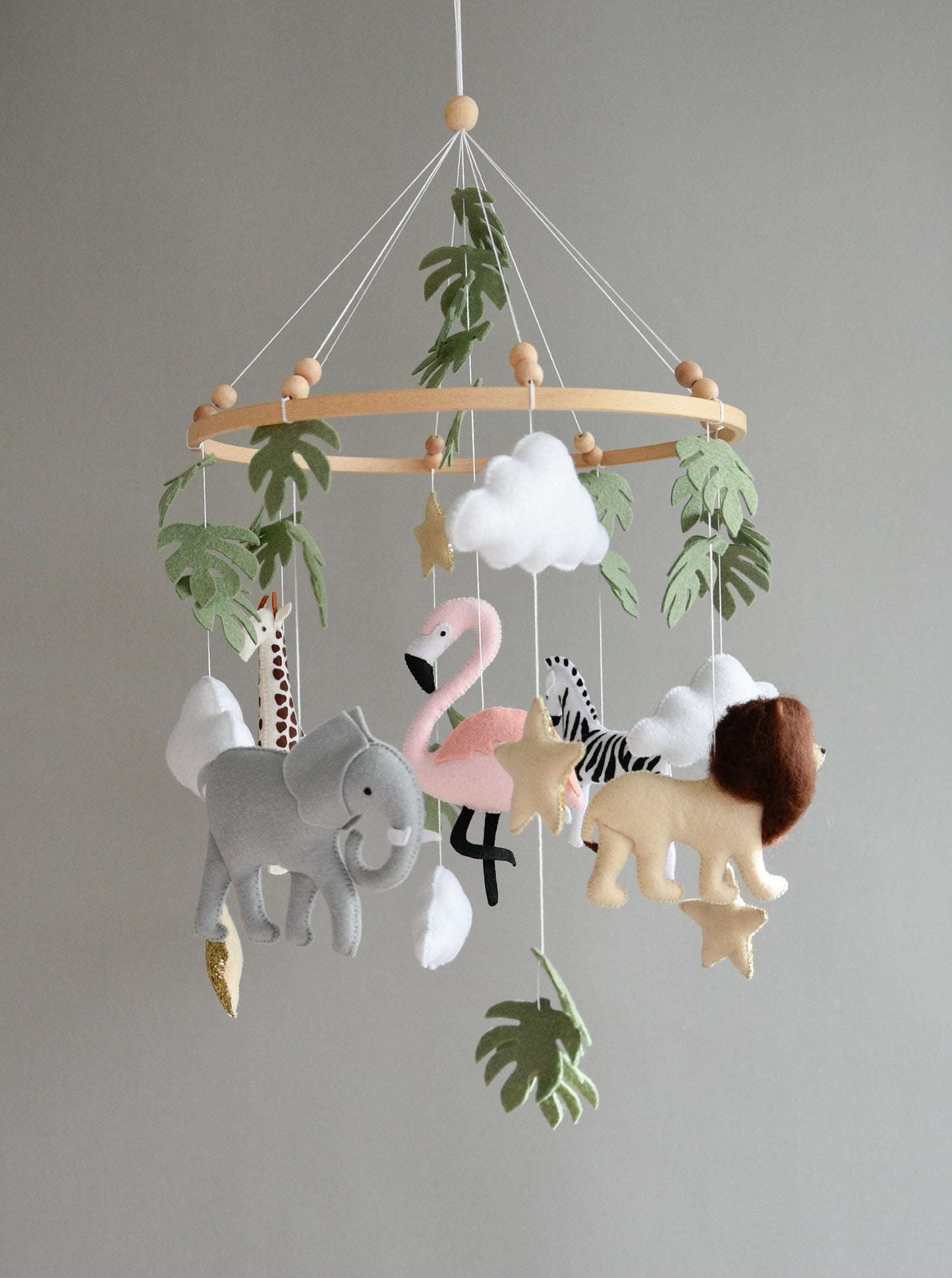 Safari mobile with lion, zebra,, flamingos, elephants, monstera leaves, stars and clouds