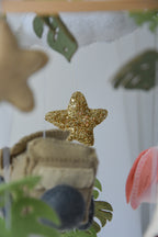 Safari mobile with offroad car, lion, zebra,, flamingos, elephants, monstera leaves, stars and clouds