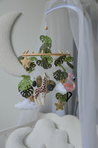 Safari mobile with offroad car, lion, zebra,, flamingos, elephants, monstera leaves, stars and clouds