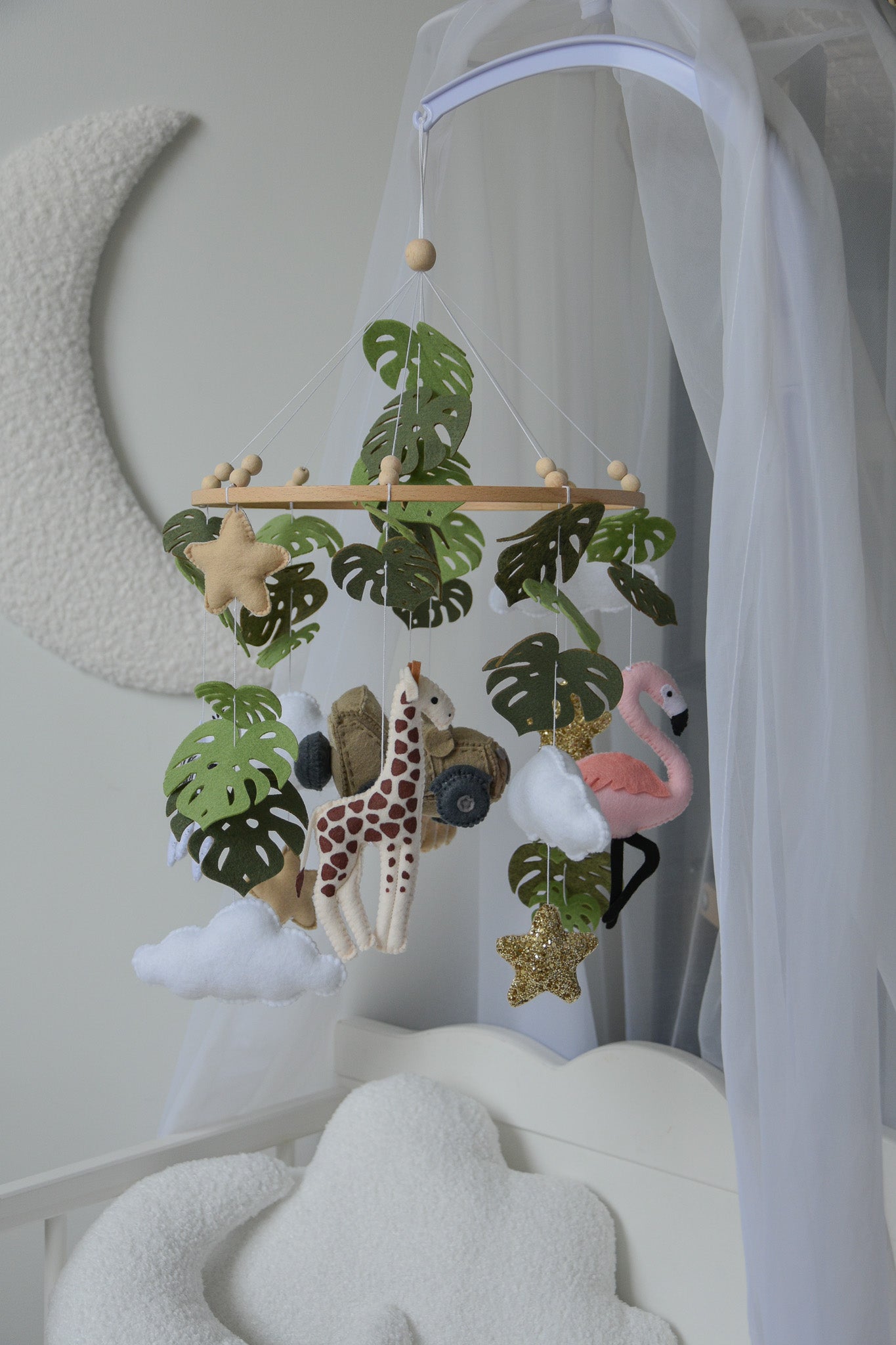 Safari mobile with offroad car, lion, zebra,, flamingos, elephants, monstera leaves, stars and clouds