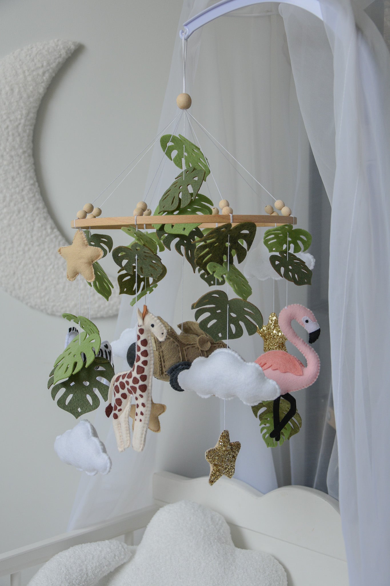 Safari mobile with offroad car, lion, zebra,, flamingos, elephants, monstera leaves, stars and clouds