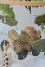 Safari mobile with offroad car, lion, zebra,, flamingos, elephants, monstera leaves, stars and clouds