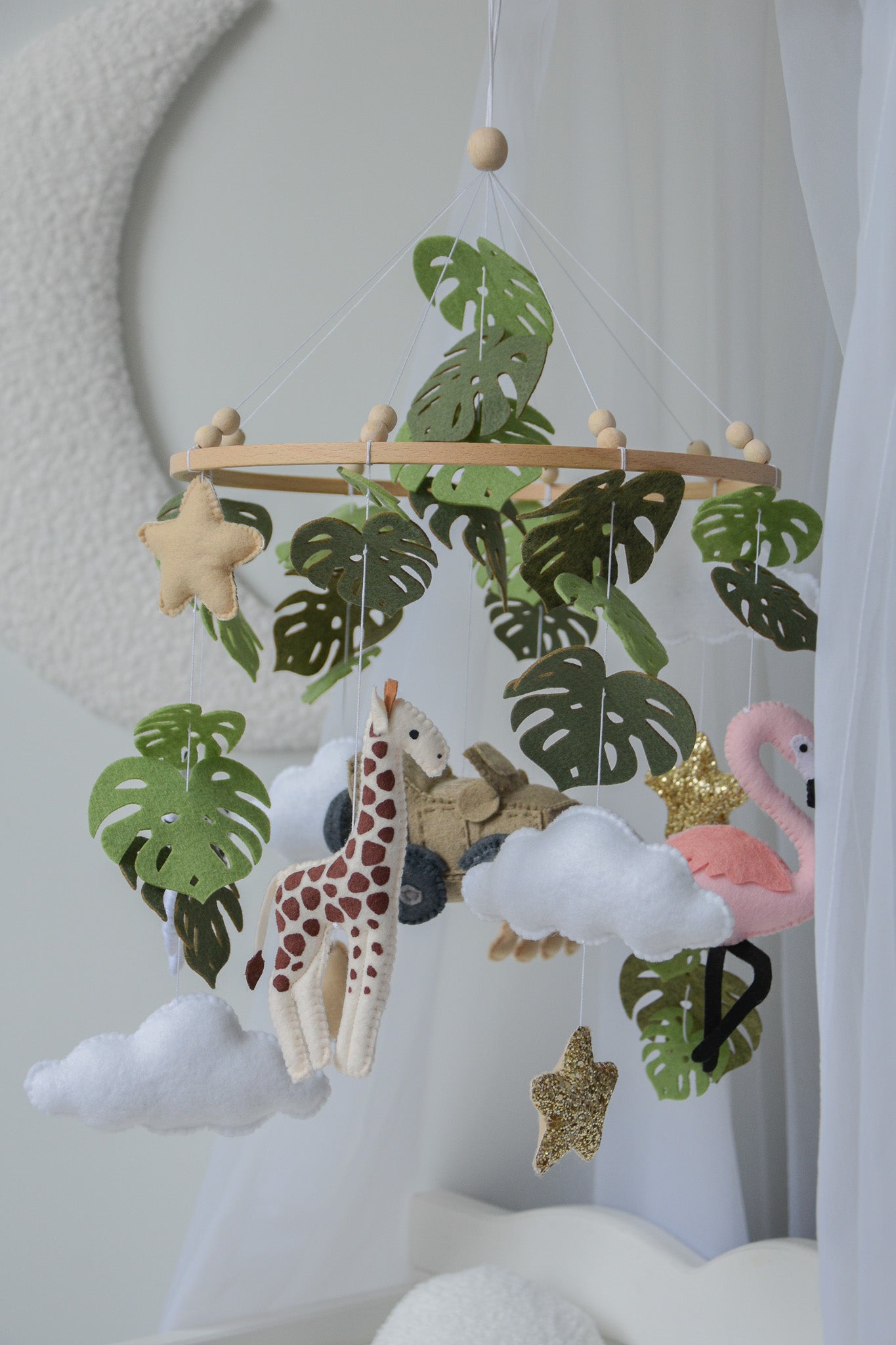 Safari mobile with offroad car, lion, zebra,, flamingos, elephants, monstera leaves, stars and clouds