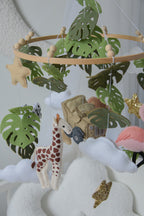 Safari mobile with offroad car, lion, zebra,, flamingos, elephants, monstera leaves, stars and clouds