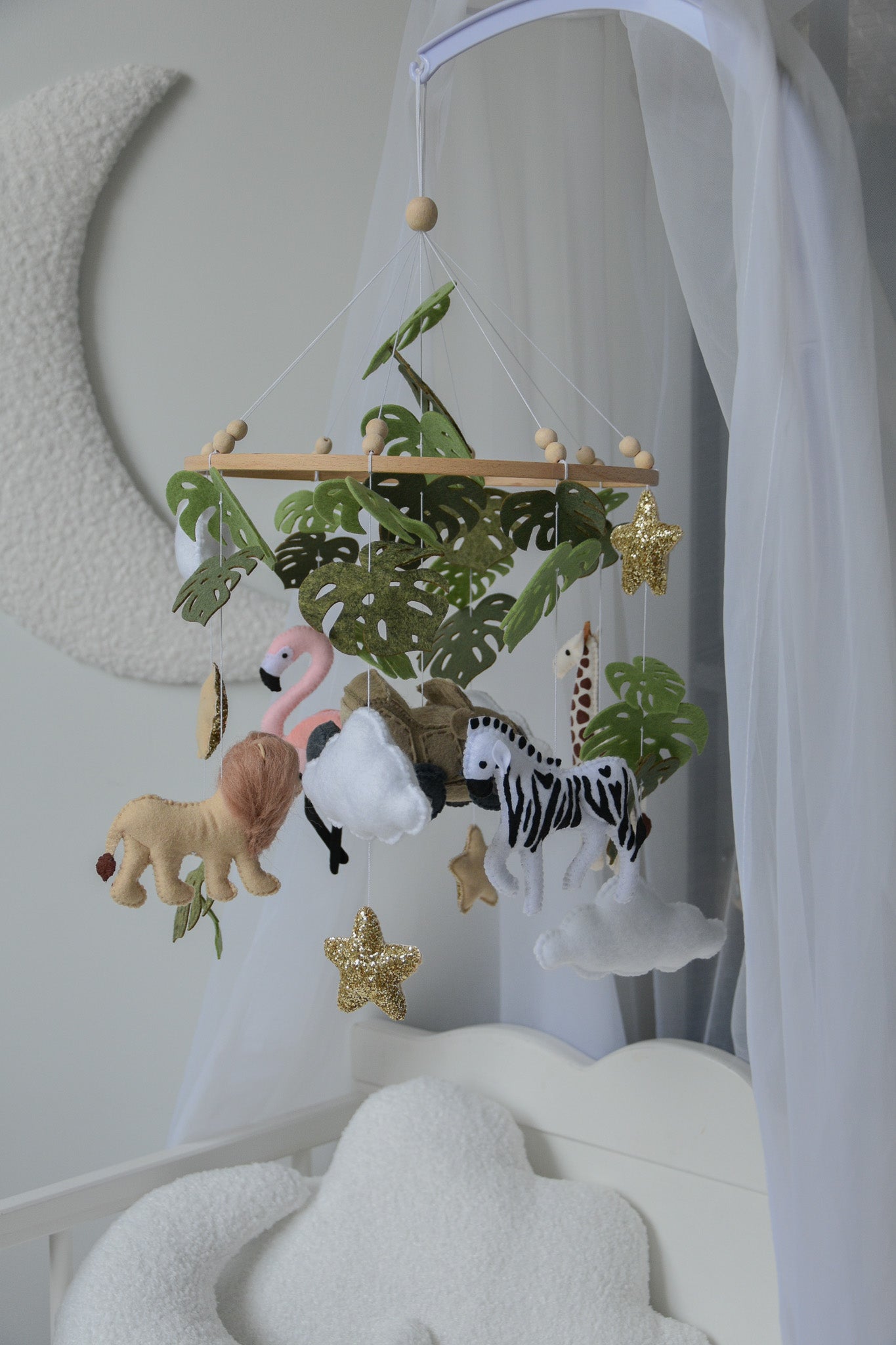 Safari mobile with offroad car, lion, zebra,, flamingos, elephants, monstera leaves, stars and clouds