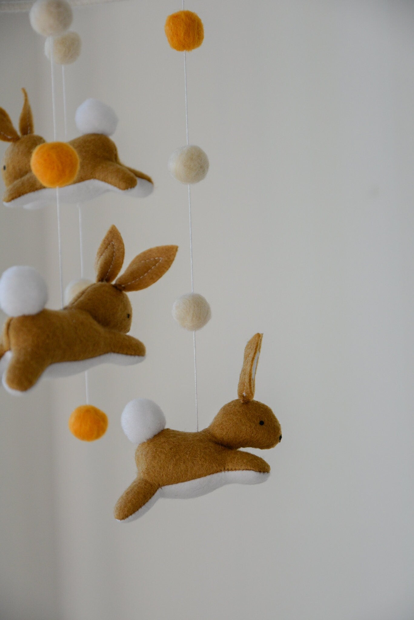 Jumping bunny mobile with felted balls