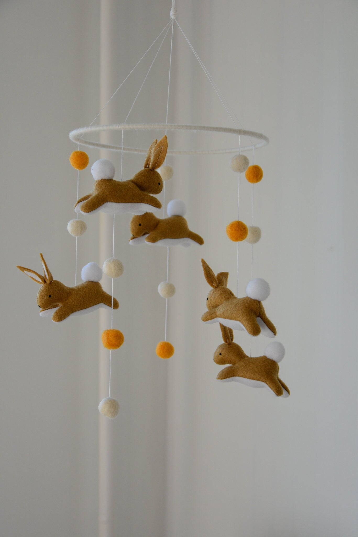 Jumping bunny mobile with felted balls