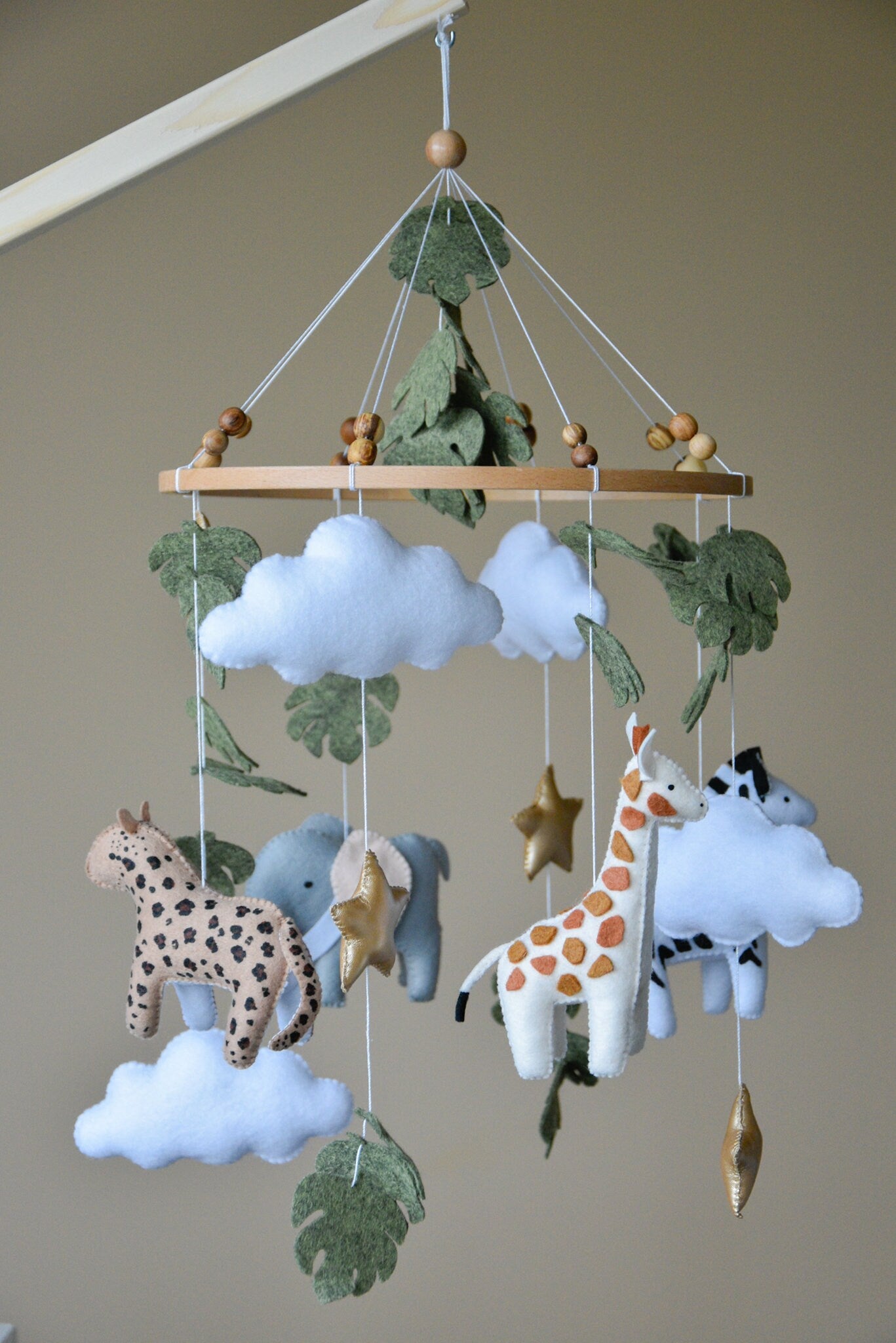 Safari mobile with cute African animals,giraffe, elephant, lion, zebra and monstera leaves