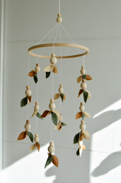 Floral mobile with wooden pearls, green, beige, brown and leaves