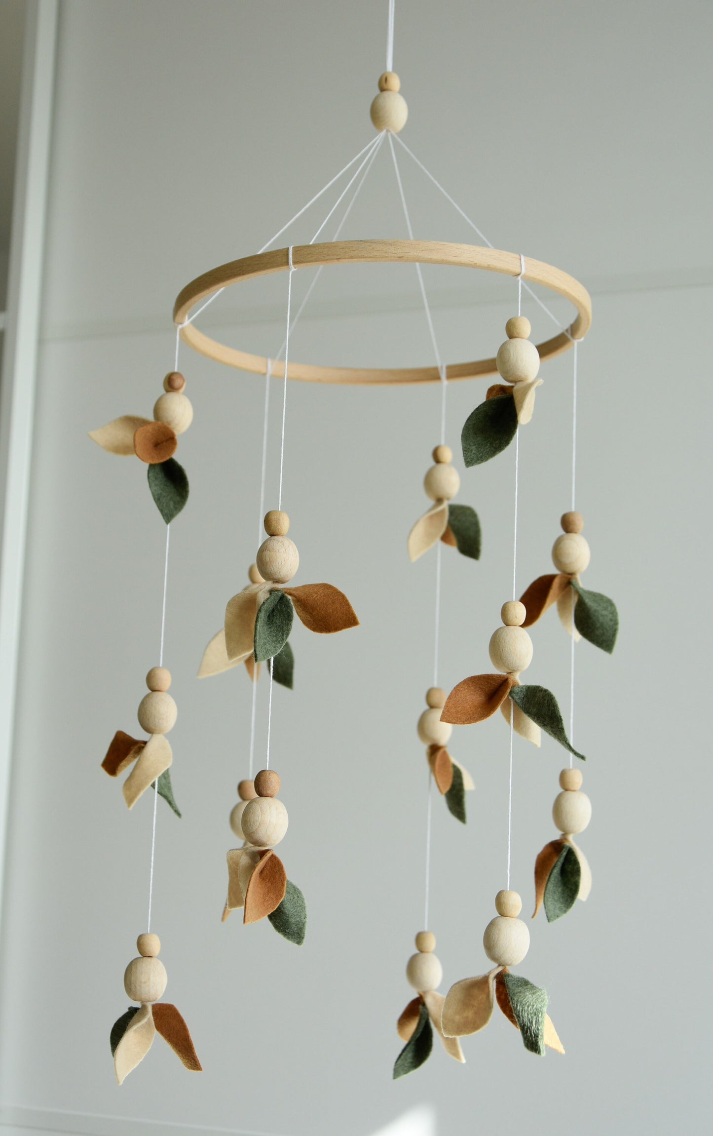 Floral mobile with wooden pearls, green, beige, brown and leaves