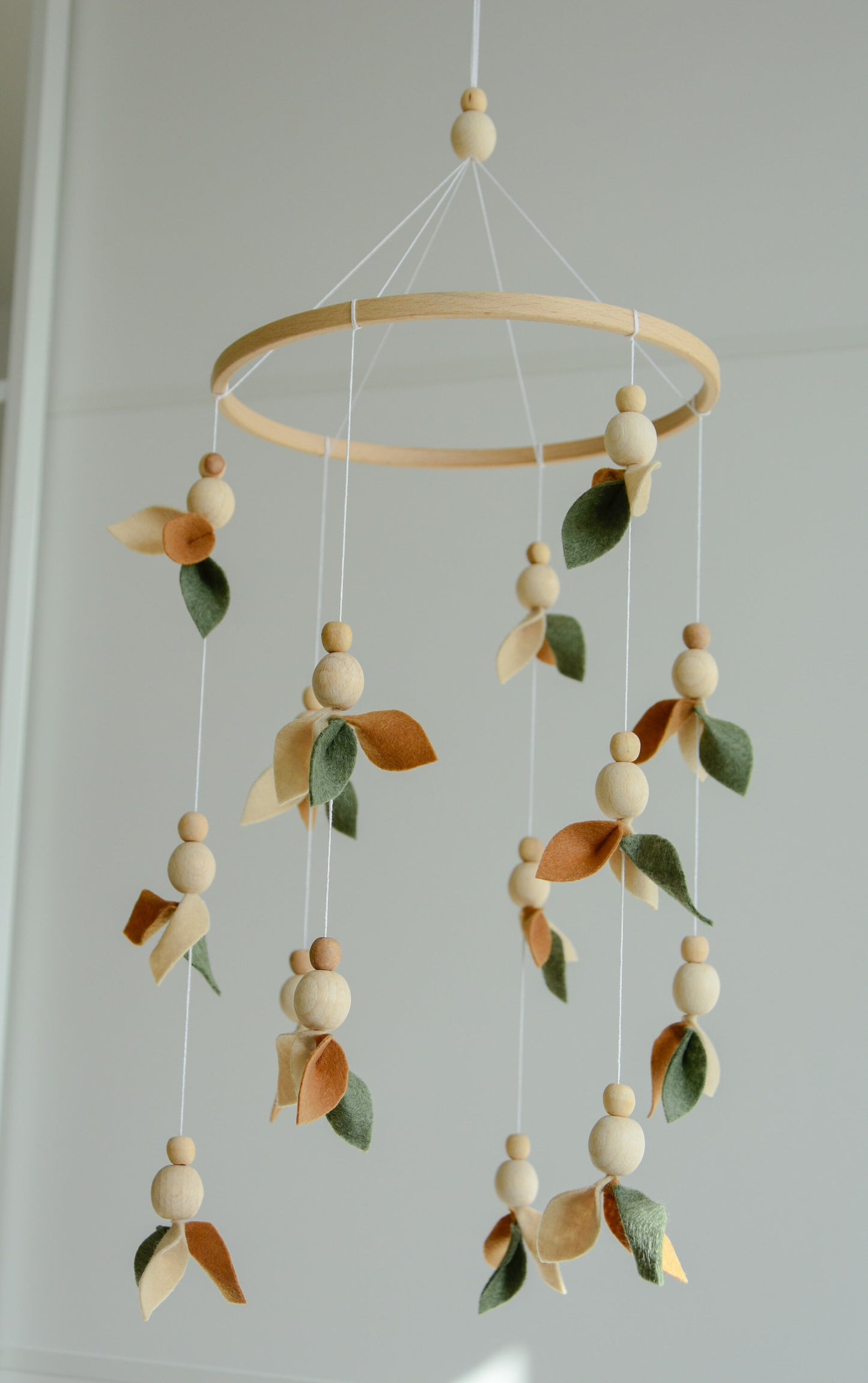 Floral mobile with wooden pearls, green, beige, brown and leaves