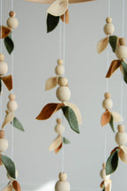 Floral mobile with wooden pearls, green, beige, brown and leaves - Minidreams Decor