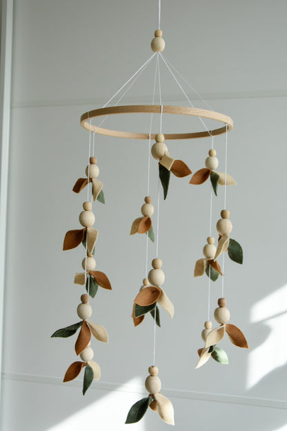 Floral mobile with wooden pearls, green, beige, brown and leaves