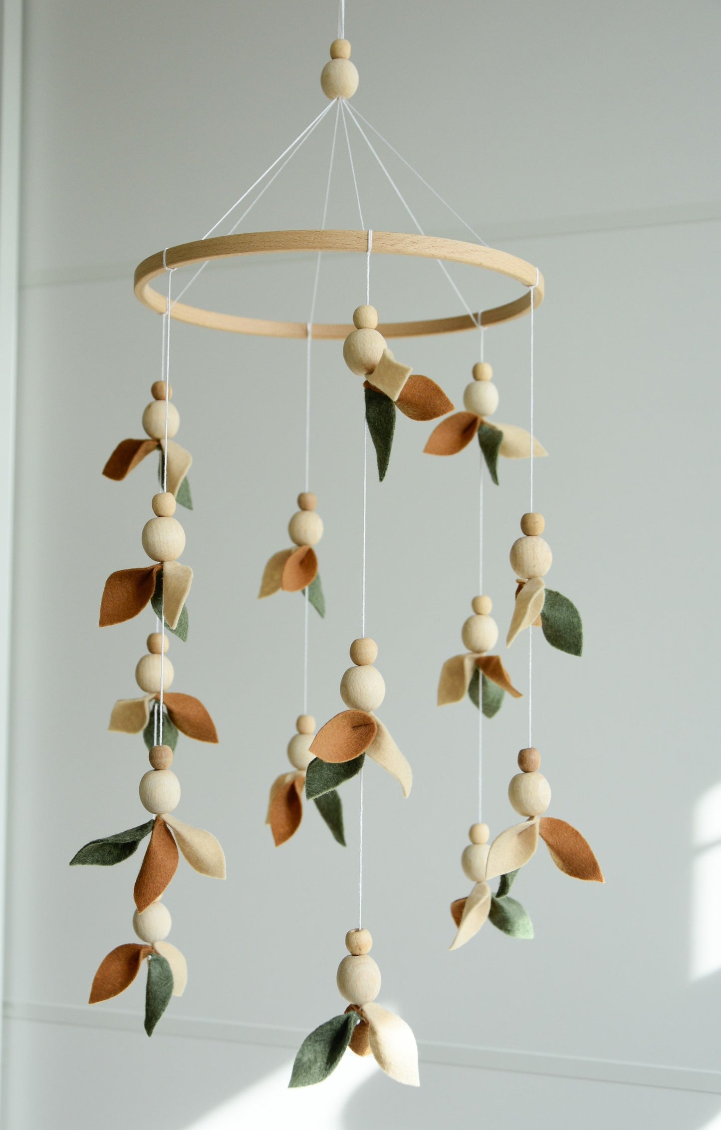 Floral mobile with wooden pearls, green, beige, brown and leaves